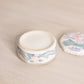 Small Hexagonal White Ceramic Lidded Jar with Pink Floral Designs