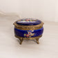 Small Oval Blue Ceramic Hinged Lidded Music Box with Floral Designs