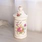 Tall Cream Ceramic Lidded Jar with Floral Designs and Gold Details