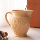 Medium Tan Ceramic Pitcher with Floral Details